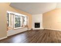 Bright living room with a white brick fireplace, large windows, and hardwood floors at 4309 Enright Ct, Winter Park, FL 32792