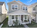 Two-story home featuring a covered front porch with chairs and table at 431 Scotsmans Pl, Debary, FL 32713