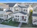 Aerial front exterior view of two-story home with covered front porch and landscaped yard at 431 Scotsmans Pl, Debary, FL 32713