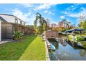 A beautiful view of the canal, backyard, boat lift, and dock of this waterfront property at 465 Mandalay Rd, Orlando, FL 32809