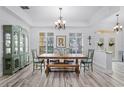 Formal dining room features wood floors, a large table with seating, and a decorative chandelier at 5219 Hammock Cir, St Cloud, FL 34771