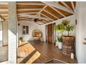 Cozy covered patio featuring wood-look tile flooring, a unique chair, and ample natural light at 533 Balmoral Rd, Winter Park, FL 32789