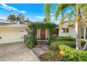 Inviting front entrance with a lush, verdant pergola, and a security system at 533 Balmoral Rd, Winter Park, FL 32789