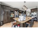 Spacious kitchen featuring dark wood cabinetry, granite countertops, and stainless steel appliances at 5361 Tortuga Dr, Orlando, FL 32837