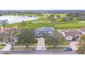 An aerial view capturing this home near a golf course and pond, highlighting the community and surroundings at 5558 Brookline Dr, Orlando, FL 32819