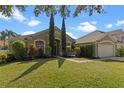 Charming single-story home with manicured lawn, mature landscaping, and a two-car garage at 644 Strihal Loop, Oakland, FL 34787