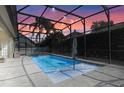 Relaxing screened-in pool area with sparkling water, patio, and string lights perfect for entertaining at 644 Strihal Loop, Oakland, FL 34787