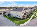 An aerial view of a meticulously landscaped townhome community showcasing the well-maintained lawns and exteriors at 696 Orange Belt Loop, Winter Garden, FL 34787