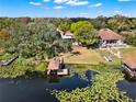 Stunning waterfront property featuring a private dock, mature trees and serene lake views at 7496 Lake Marsha Dr, Orlando, FL 32819