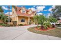 Elegant two-story home with a tile roof, beautiful landscaping, and a spacious driveway at 7655 Debeaubien Dr, Orlando, FL 32835