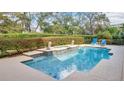 Relaxing backyard pool featuring elegant design elements and comfortable seating for outdoor enjoyment at 7655 Debeaubien Dr, Orlando, FL 32835