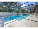 Screened-in pool with water feature, sun shelf, and ample space for relaxing and entertaining at 814 Kazaros Cir, Ocoee, FL 34761