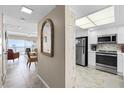 Bright kitchen featuring stainless steel appliances and a view of the living area and ocean beyond at 815 Ocean Shore Blvd # U7A, Ormond Beach, FL 32176