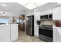 Well-lit kitchen equipped with stainless steel appliances and white cabinetry at 815 Ocean Shore Blvd # U7A, Ormond Beach, FL 32176