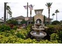 A clubhouse with American flags and a water fountain surrounded by well-maintained landscaping at 8168 Boat Hook Loop # 707, Windermere, FL 34786