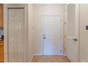 Bright hallway with tile flooring, a front door, and closet doors for ample storage at 8168 Boat Hook Loop # 707, Windermere, FL 34786