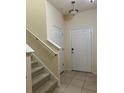 Bright foyer featuring tile flooring, stairway to the left and a front door at 8237 Serenity Spring Dr # 2605, Windermere, FL 34786