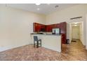 Open-concept kitchen with dark wood cabinets, breakfast bar, and modern stainless steel appliances at 832 Westshore Ct, Casselberry, FL 32707