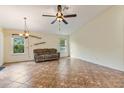 Spacious living area with neutral walls, tile flooring, and a ceiling fan for comfort at 832 Westshore Ct, Casselberry, FL 32707