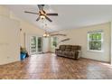 Bright living room featuring vaulted ceilings, tile floors, and sliding glass doors to a patio at 832 Westshore Ct, Casselberry, FL 32707