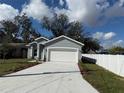 Well maintained single Gathering home featuring a manicured lawn, fresh exterior paint, and a white picket fence at 1012 India Ave, Haines City, FL 33844