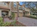 Charming townhome with a stone facade, two-car garage, and a well-manicured front yard at 10509 Belfry Cir, Orlando, FL 32832