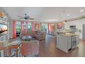 Spacious living room featuring hardwood floors, comfortable seating, and a modern, open kitchen at 10509 Belfry Cir, Orlando, FL 32832