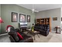 Cozy living room with comfortable leather furniture, neutral walls, and decorative artwork at 11716 Astilbe Dr, Orlando, FL 32827