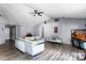 Spacious living room featuring vaulted ceilings, modern flooring, and stylish neutral decor at 1909 Michigan Way, Poinciana, FL 34759