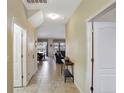 Inviting hallway with tile flooring and neutral walls, leading to the living spaces at 2383 Victoria Dr, Davenport, FL 33837