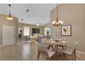 Bright living room with vaulted ceilings, tile floors, and a ceiling fan at 2625 Albion Ave, Orlando, FL 32833