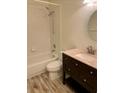 Cozy bathroom featuring a tub and shower combination, and a dark vanity with a sink and a light pink countertop at 2740 Burwood Ave, Orlando, FL 32837