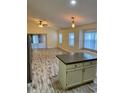 Open-concept living room featuring wood-look floors, neutral paint and sliding glass doors to the outdoors at 2740 Burwood Ave, Orlando, FL 32837