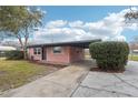 Charming single-story home with an attached carport and a concrete driveway leading to the entrance at 2943 Truman Blvd, Sanford, FL 32771