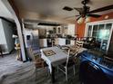 Open dining room with a ceiling fan, tile floors, and a dining table for six at 3430 Kathy Ct, Lakeland, FL 33810