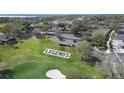 Aerial view of the Legends community entrance sign, parking area, and golf course at 3819 Breckinridge Ln, Clermont, FL 34711