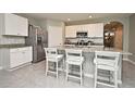 Eat-in kitchen with stainless steel appliances, a kitchen island, and bright white cabinetry at 3987 Silverstream Ter, Sanford, FL 32771