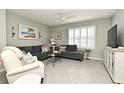 Bright living room with a modern sofa, a stylish side table, and natural light at 3987 Silverstream Ter, Sanford, FL 32771