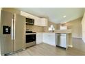 Stainless steel appliances, white cabinets, and modern finishes enhance this well-equipped kitchen at 425 Cadenza Dr, Orlando, FL 32807