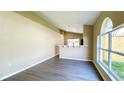 Bright living room with modern flooring, neutral paint, and large windows at 425 Cadenza Dr, Orlando, FL 32807