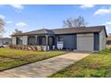 Front exterior of a single-story house with a long driveway and a well-manicured lawn at 4804 Laddie Ct, Orlando, FL 32821