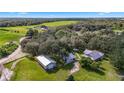 Expansive property featuring multiple structures, open fields, and surrounded by lush forest at 5335 Canoe Creek Rd, St Cloud, FL 34772