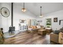 Cozy living room features wood floors, shiplap walls, and a charming wood-burning stove at 5335 Canoe Creek Rd, St Cloud, FL 34772