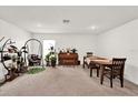 Bright living room with plants, piano, swing chair and dining table at 545 Jerry Ln, Haines City, FL 33844