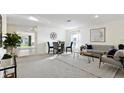 Open-concept living room with carpeted floors, modern furniture, and lots of natural light at 545 Jerry Ln, Haines City, FL 33844