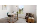 A bright home office with a stylish desk, a comfortable chair, and a view of the neighborhood at 545 Jerry Ln, Haines City, FL 33844