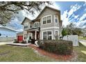 Inviting two-story home with a red garage door and a beautifully landscaped front yard at 546 Nogales Ct, Kissimmee, FL 34758