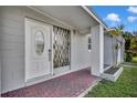 Inviting entryway features a decorative front door, brick flooring, and neutral color palette at 5844 Bamboo Dr, Orlando, FL 32807