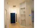 Bright foyer featuring tile flooring, a modern light fixture, and a built-in shelving unit at 6501 Abercrombie Ct, Orlando, FL 32835