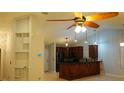 Bright kitchen with dark wood cabinets, black appliances, and stylish pendant lighting at 6501 Abercrombie Ct, Orlando, FL 32835